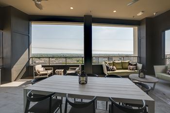 A modern dining room with a table set for six.